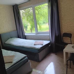 a room with a bed and a window and a couch at Valva vila in Luokesos Sen +8 photos