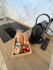 a table with a tray of food and a remote control at Appartamento Debbis Home Misano Adriatico in Misano Adriatico