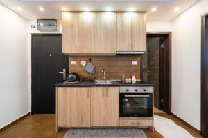 a kitchen with a sink and a stove at BlueMont Apartment in Podgorica
