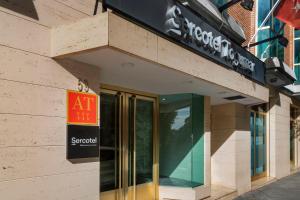 a sign on the side of a building with a exit sign at Sercotel Togumar in Madrid
