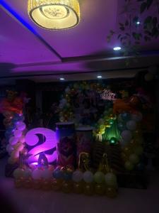 a party with balloons and a purple ceiling at Sea rock hotel in Gangānagar