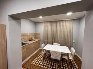 a kitchen with a table and chairs in a room at Апарт Хотел Любимец in Lyubimets +8 photos