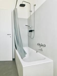 a white bathroom with a sink and a shower at Appartamento Debbis Home Misano Adriatico in Misano Adriatico +27 photos