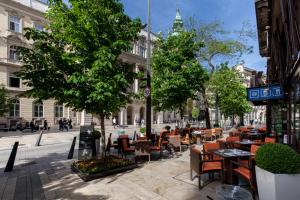 a street with tables and chairs on a city street at Boutique Apartment in Budapest Downtown in Budapest