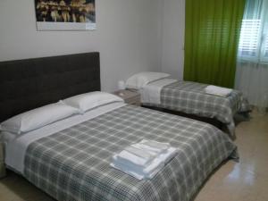Posteľ alebo postele v izbe v ubytovaní Olimpica Relais guest house