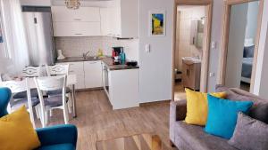a living room with a couch and a kitchen at MGE Luxury house with pool in Iraklitsa