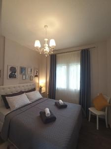 a bedroom with a bed with two towels on it at MGE Luxury house with pool in Iraklitsa +32 photos