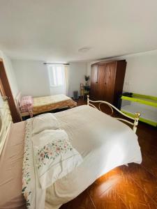 a bedroom with a large bed with white sheets at O Sitio da Paz in Robalo +31 photos