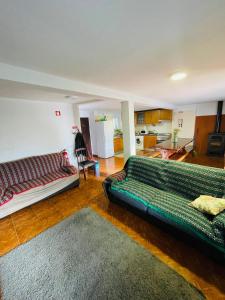 a living room with a couch and a kitchen at O Sitio da Paz in Robalo