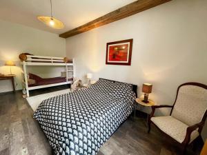a bedroom with a bed and a chair at Gîte à Oisly près des Châteaux de la Loire avec Parking et Animaux Bienvenus - FR-1-491-469 in Oisly