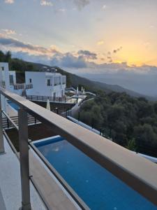 a view from the balcony of a house with a swimming pool at Kandania Paradise in Kántanos