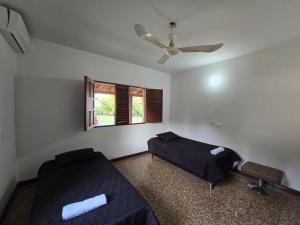 a bedroom with two beds and a ceiling fan at Finca Hotel Galilea Doradal in Doradal +26 photos