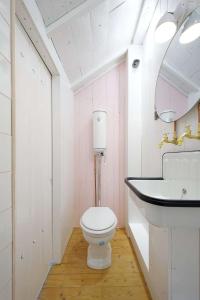 a bathroom with a white toilet and a sink at TheVillaRose in Wimereux