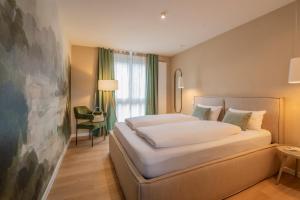 a hotel room with a large bed and a window at Adler Apartments in Ettenheim