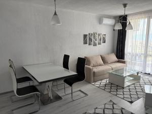 a living room with a table and a couch at Трушеви in Sandanski