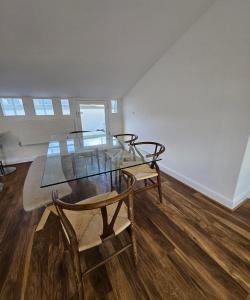a dining room with a glass table and chairs at Victoria, Haru Residence 6bed Room and 4bath Rooms Apartment in London +19 photos
