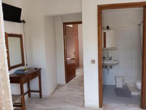 a bathroom with a sink and a toilet and a mirror at renesis studios in Lithakia