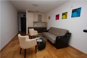 a living room with a couch and a table and chairs at The Old Town Terrace Apartments in Budva