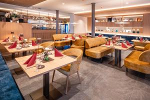 a restaurant with tables and chairs and a bar at Schloss Hotel Wasserburg in Wasserburg am Bodensee +36 photos