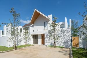 a white house with trees in front of it at 4BR Private Pool Villa near Laguna & Beach - Lux Pride 2 by Warm Plus in Ban Pak Lak