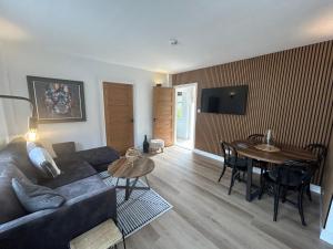 a living room with a couch and a table at The Hideaway - 2-Bedroom Apartment with outdoor terrace & free parking in Lancaster