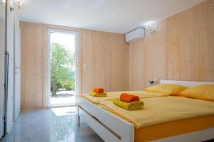 a bedroom with a large bed with towels on it at Vila Porto Olive Heated Pool near Piran & Portorož in Portorož