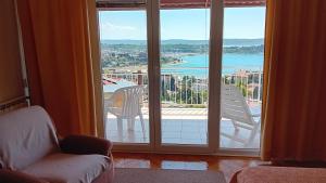 a room with a large window looking out at the water at Apartments Heidi in Portorož