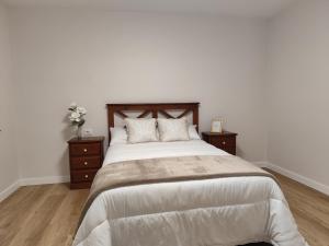 a bedroom with a large bed with two night stands at Cangas con encanto in Cangas de Morrazo +13 photos