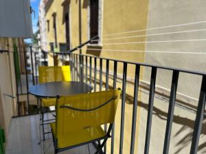 a yellow table and chairs on a balcony at Dream Suite Mare Giovinazzo in Giovinazzo