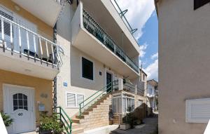 an apartment building with stairs and a balcony at Cozy Apartment In Baska Voda With Wifi in Baška Voda