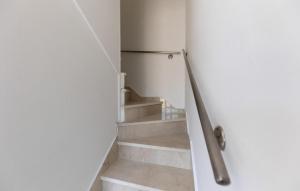 a door leading to a staircase with a refrigerator at Cozy Apartment In Baska Voda With Wifi in Baška Voda