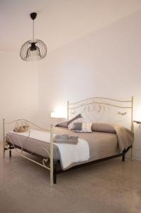 a bedroom with a bed with a white bed frame at Casale Nonno Dario, Balcone delle Marche Cingoli in Troviggiano