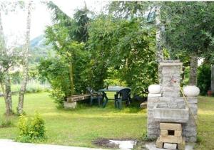 a garden with a table and a picnic table at Girasole in Vittorio Veneto