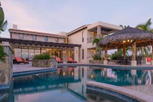 a resort with a swimming pool and a building at Villa de Suenos by Cabo Villas in San José del Cabo
