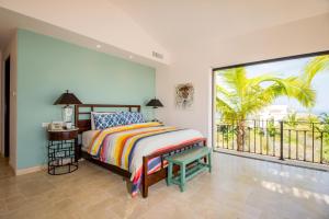 a bedroom with a bed and a large window at Villa de Suenos by Cabo Villas in San José del Cabo +24 photos