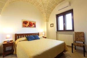 a bedroom with a bed and a window at Borgo Antico in Diso