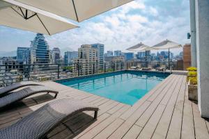 a balcony with a swimming pool on top of a building at Time Suite - Comfort Apartments in Santiago