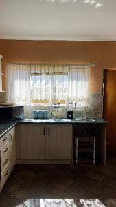 a kitchen with a counter top and a window at The 2nd Seagull in Swakopmund +8 photos