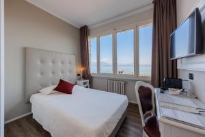 Postel nebo postele na pokoji v ubytování Hotel Degli Oleandri