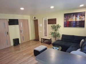 a living room with a couch and a table at Amber Stay Birštonas in Birštonas