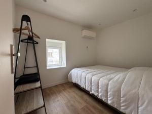 a bedroom with a bed and a ladder in it at La Casetta - Essoyes - 4prs - Wifi in Essoyes