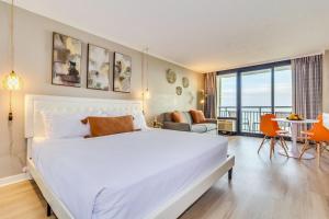 a bedroom with a large bed and a living room at WINTER RATES! Stunning Oceanfront Studio Suite, Dogs OK! 1228 in Myrtle Beach +34 photos