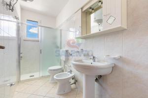 a bathroom with a sink and a toilet and a shower at Salentoandmore-Stella del mare in Torre Pali +14 photos