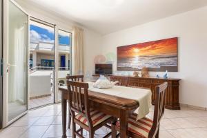 a dining room with a table and views of the ocean at Salentoandmore-Stella del mare in Torre Pali