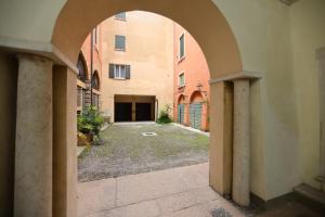 an archway leading to a courtyard in a building at La Pigna Suites in Verona +28 photos