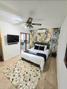 a bedroom with a bed and a ceiling fan at L'Orée du Loup in La Colle-sur-Loup