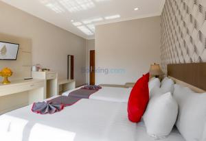 Postel nebo postele na pokoji v ubytování The Kanjeng Hotel Kuta