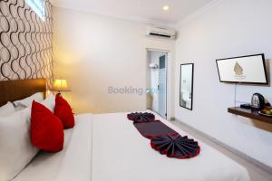 Postel nebo postele na pokoji v ubytování The Kanjeng Hotel Kuta