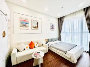 a bedroom with a bed and a couch and a window at Studio VIP Luxury Masteries OCP1 in Gia Lâm Pho +9 photos