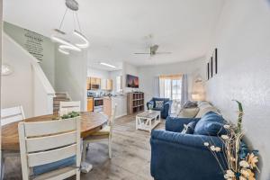 a living room and kitchen with a blue couch and a table at Cozy Stylish Townhome in Davenport